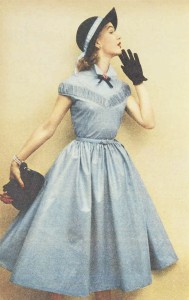1960's woman in blue dress searching for something black gloves and black bow, hat and clutch